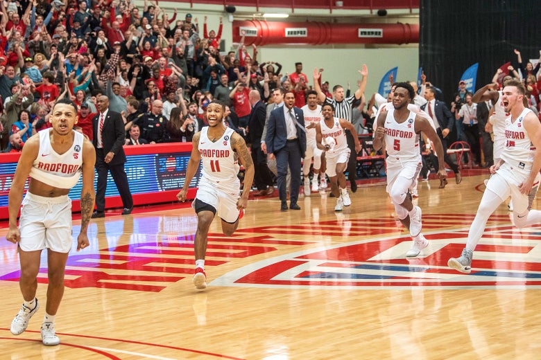 Radford guard Carlik Jones, left, celebrates after sinking a three-point basket to win as teammates Travis Fields Jr. (11), Donald Hicks (5) and Caleb Tanner, right, also celebrate after the Big South Conference championship NCAA college basketball game against Liberty on Sunday, Mar. 4, 2018.